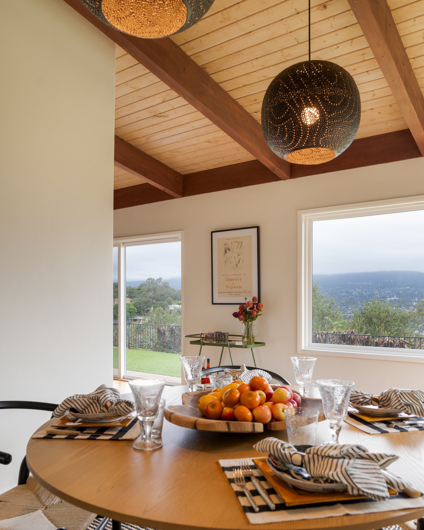 A dining table set beneath open beams